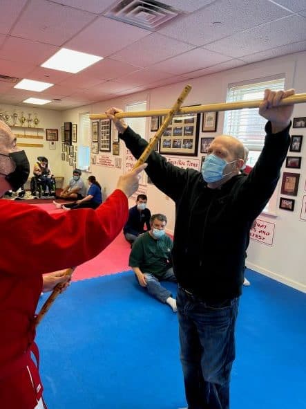 Man practicing martial arts with instructor.