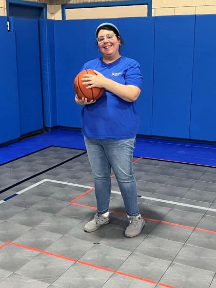 Woman holding a basketball.