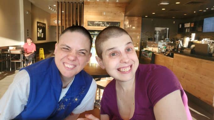 Close up of two smiling girls at Starbucks.